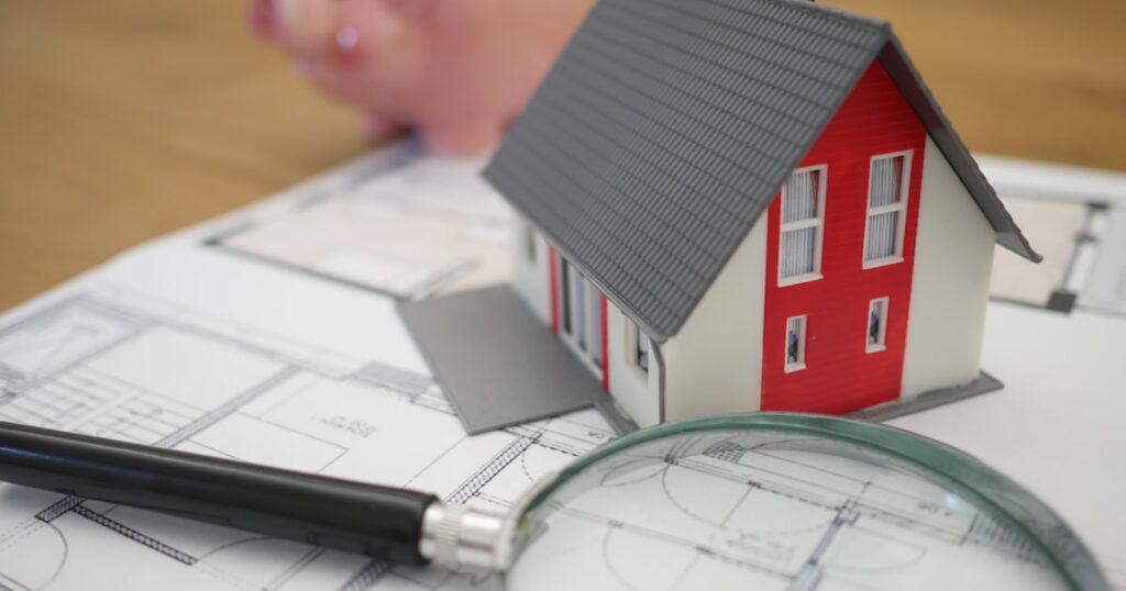 Home insurance documents and house model