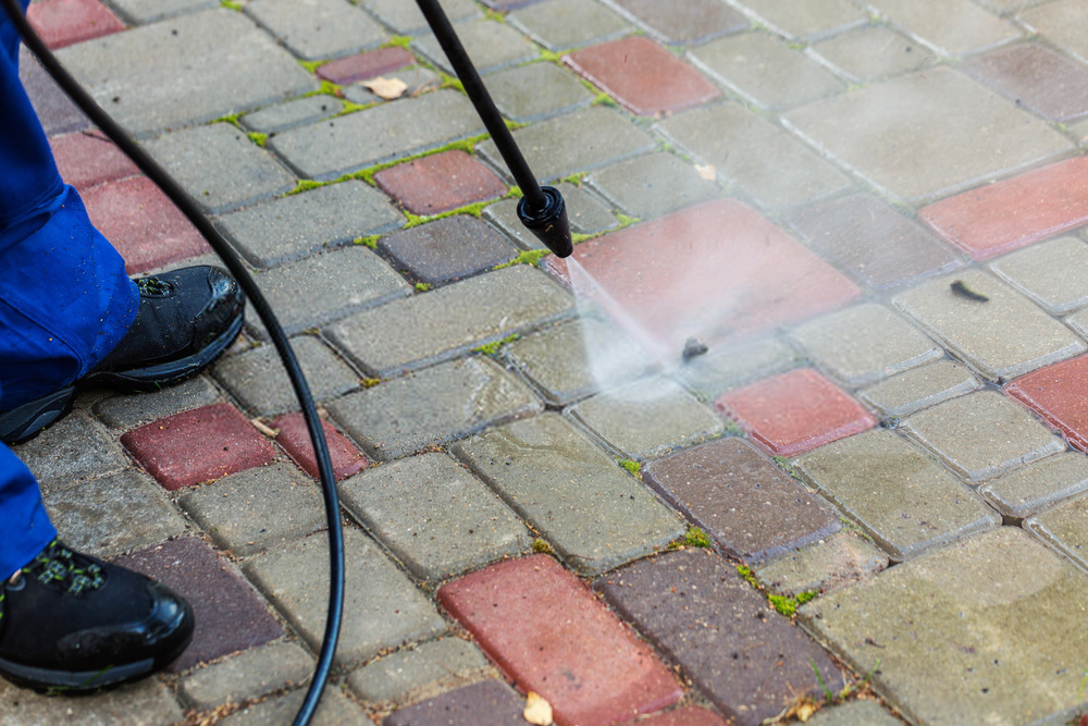 Pressure washing a concrete driveway before selling a home